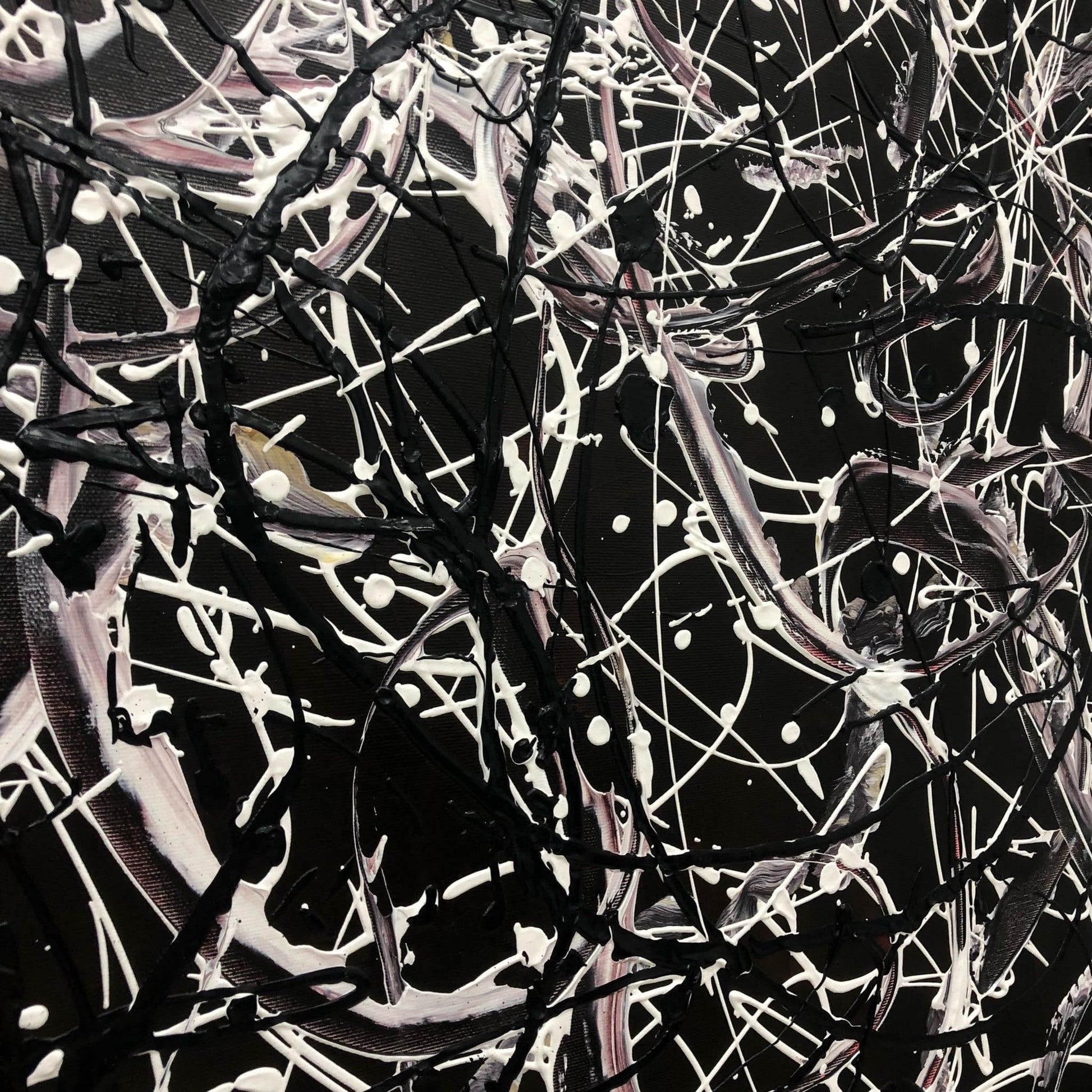 The image is an abstract painting with a black and white color scheme, featuring a chaotic and intricate pattern of lines, shapes, and splatters.
