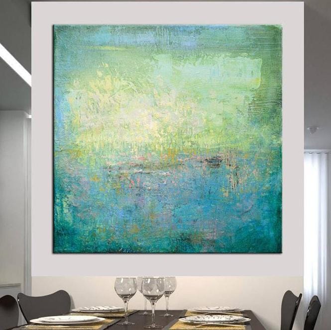 a large abstract painting hanging on a wall above a dining table with wine glasses and plates.