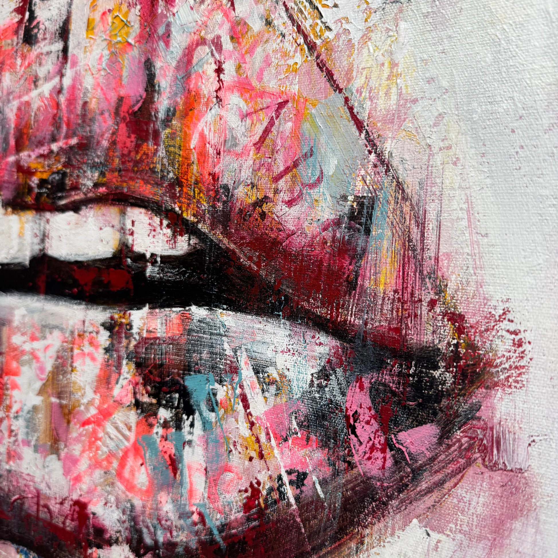The image is a close-up of a vibrant, abstract painting featuring bold, expressive brushstrokes in a variety of colors, including red, pink, yellow, and blue.