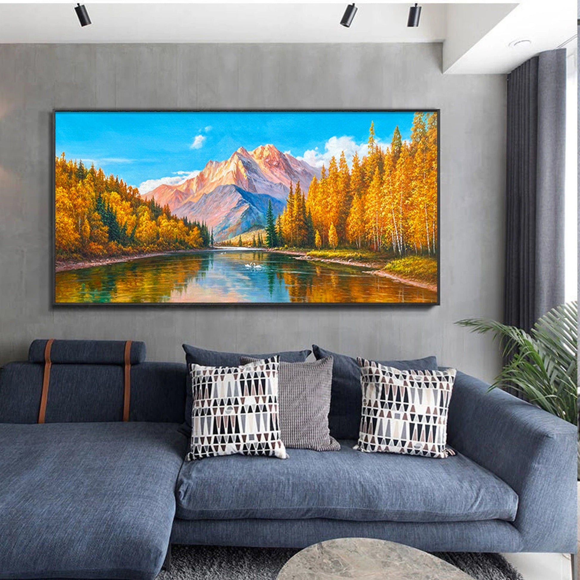 a living room with a couch and a painting on the wall