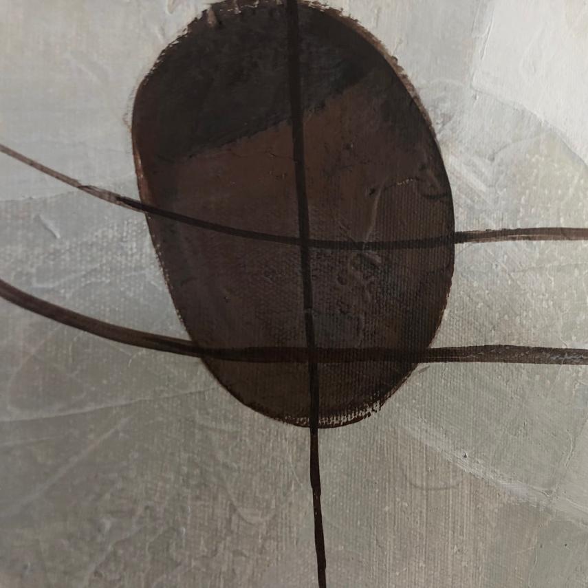 The image is a close-up of a dark brown oval shape with a horizontal line across it, set against a white background.