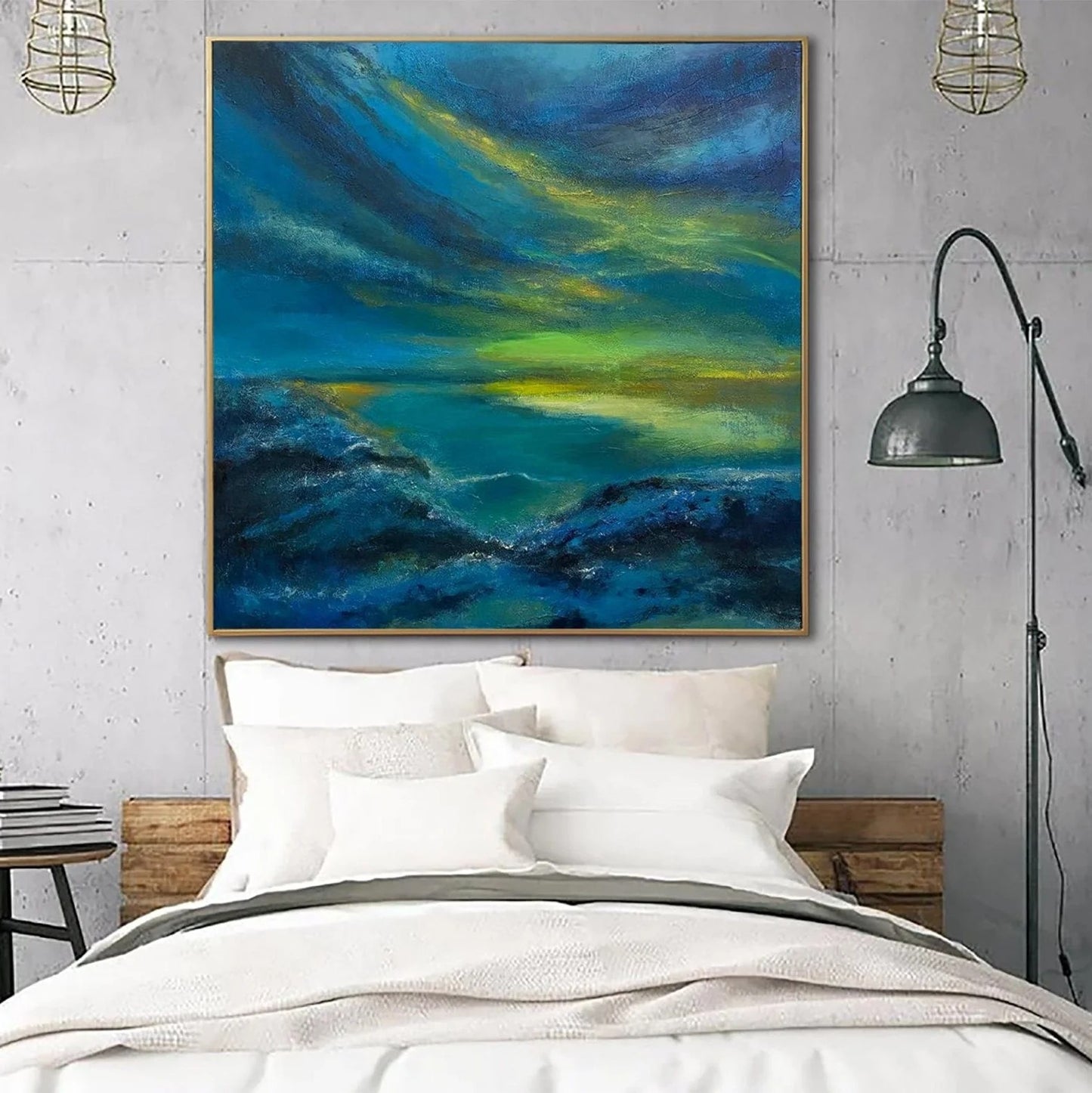 a large, vibrant painting of a seascape hanging above a bed with white pillows and a gray blanket.