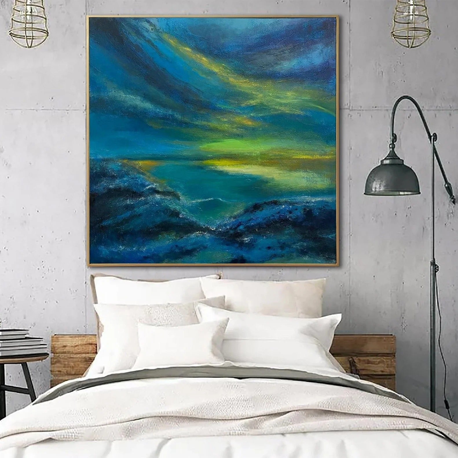 a large, vibrant painting of a seascape hanging above a bed with white pillows and a gray blanket.