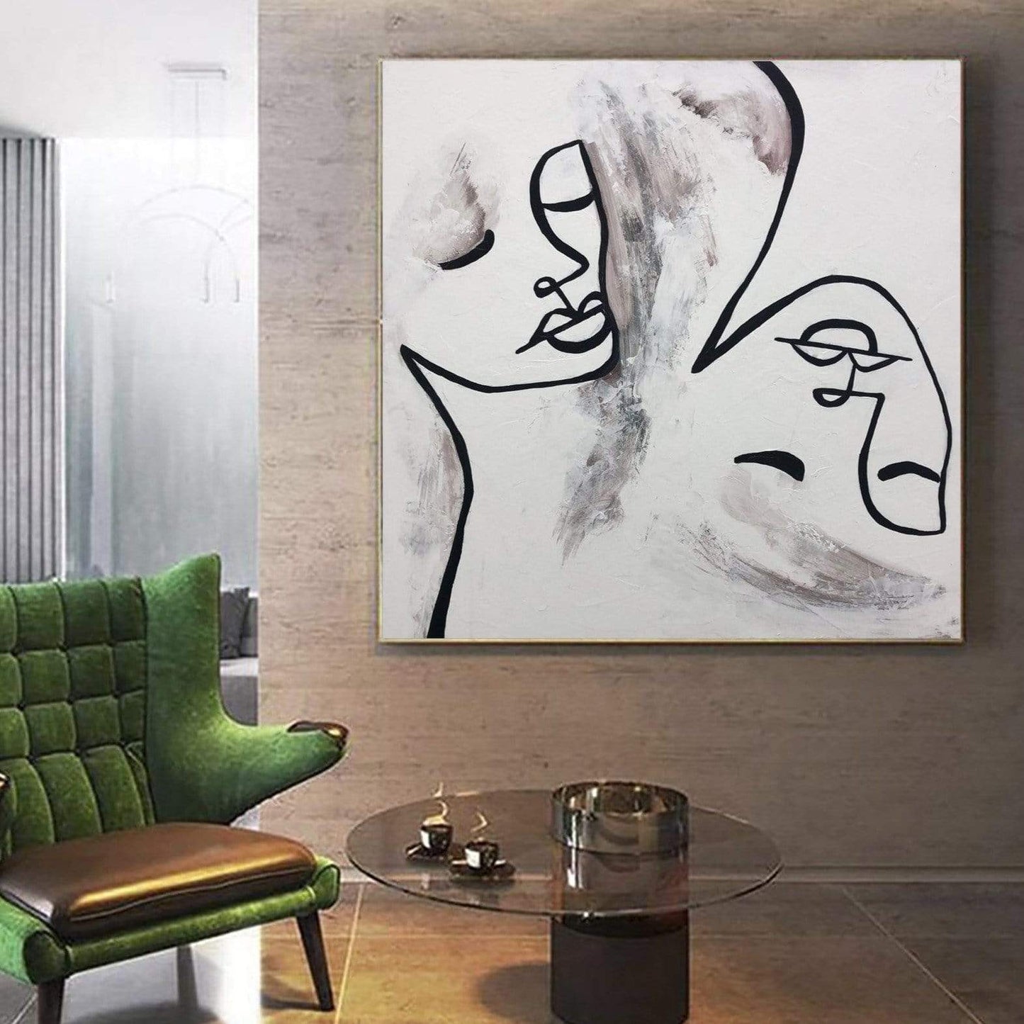 a living room with a green chair and a painting on the wall