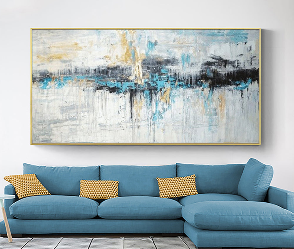 a living room with a blue couch and a large painting on the wall