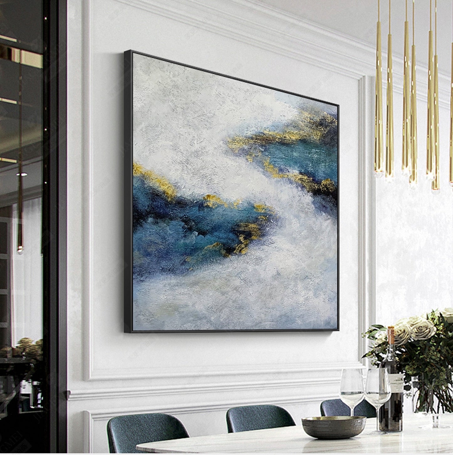 a painting hanging on a wall above a dining room table