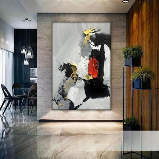 a modern and stylish interior design with a large abstract painting as the focal point. The painting has bold black and white colors, with splashes of red and orange, creating a striking contrast against the gray background. The room is furnished with a dining table, chairs, and potted plants, contributing to the overall contemporary aesthetic.