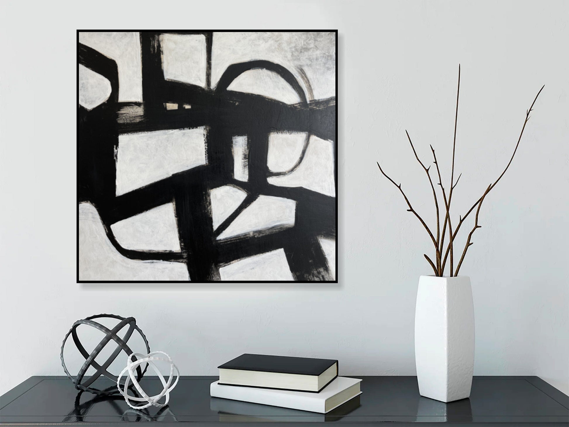 a black and white painting on a white wall