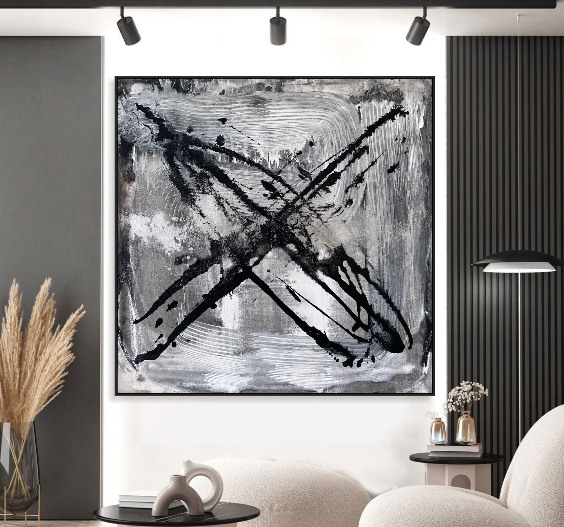 a black and white painting hanging on a wall