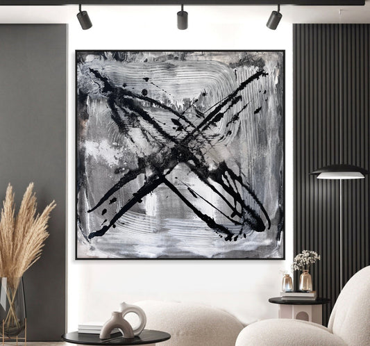 a black and white painting hanging on a wall