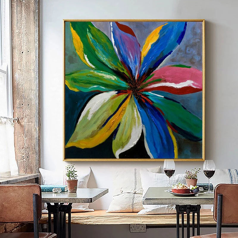 a painting of a flower on a wall above a table