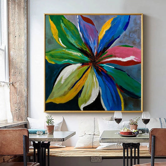 a painting of a flower on a wall above a table