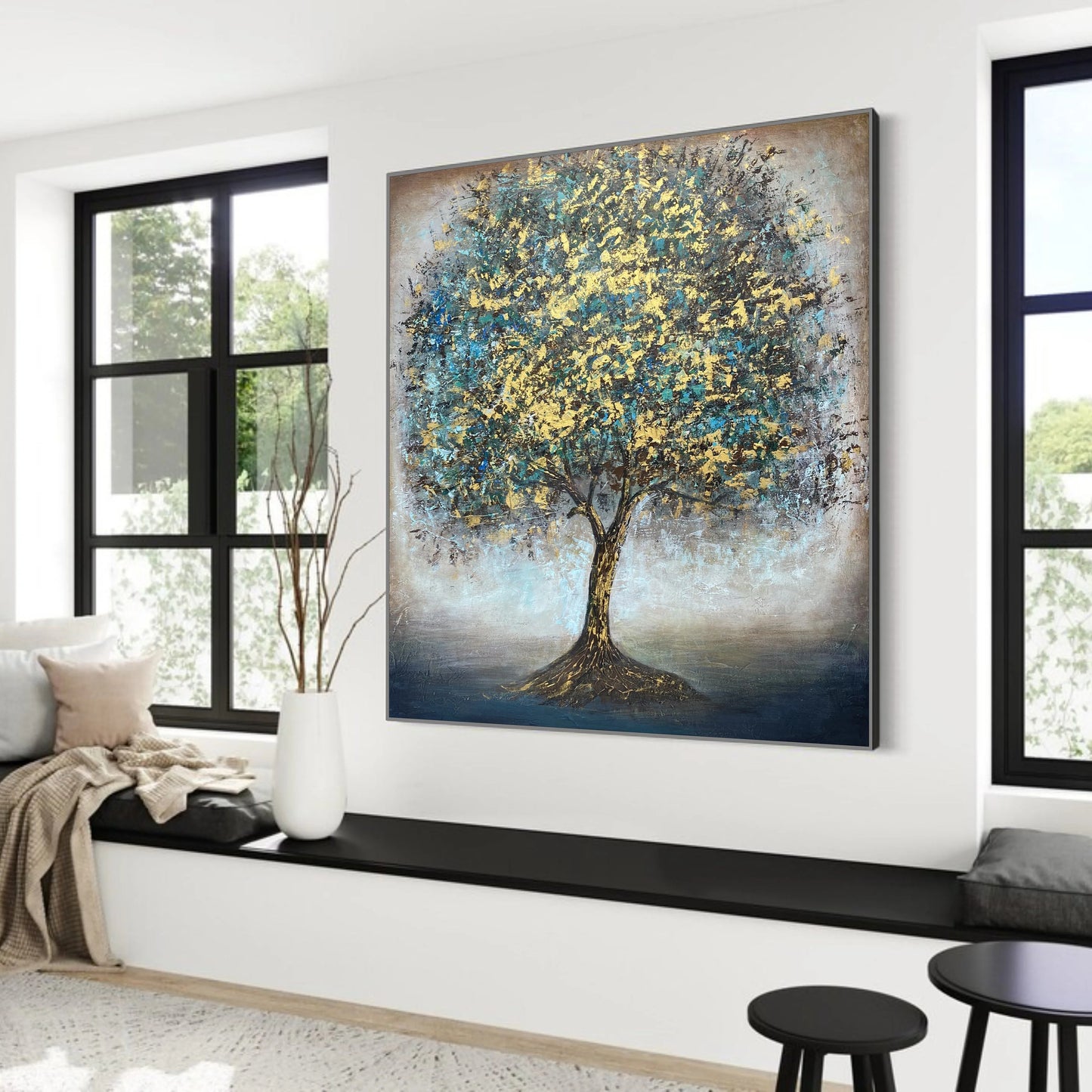 a large painting of a tree with a blue and yellow color scheme, hanging on a wall in a room with large windows.