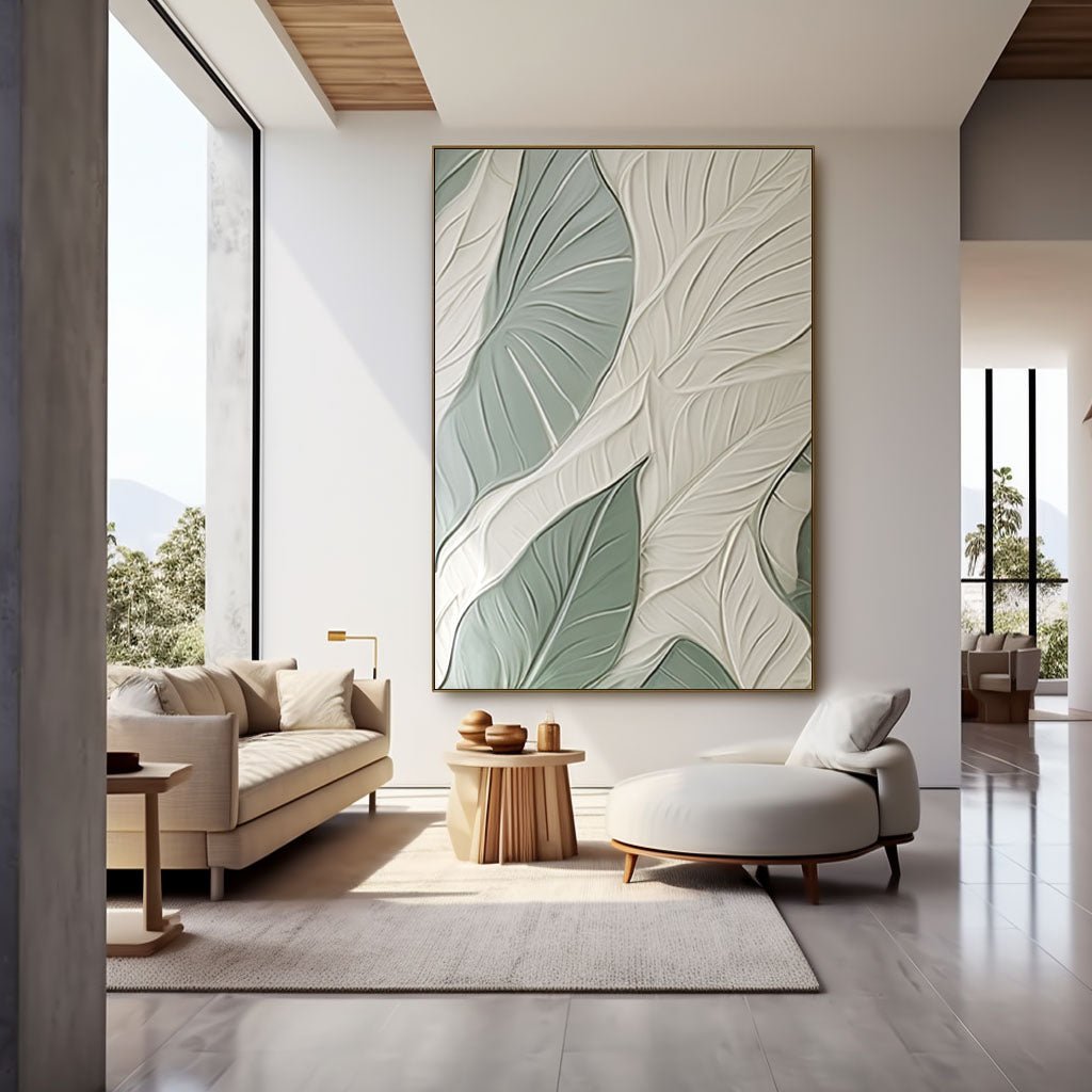 a modern living room with a large abstract painting featuring green and white leaf patterns on the wall. The room is furnished with a sofa, a chair, and a coffee table, creating a comfortable and stylish space.