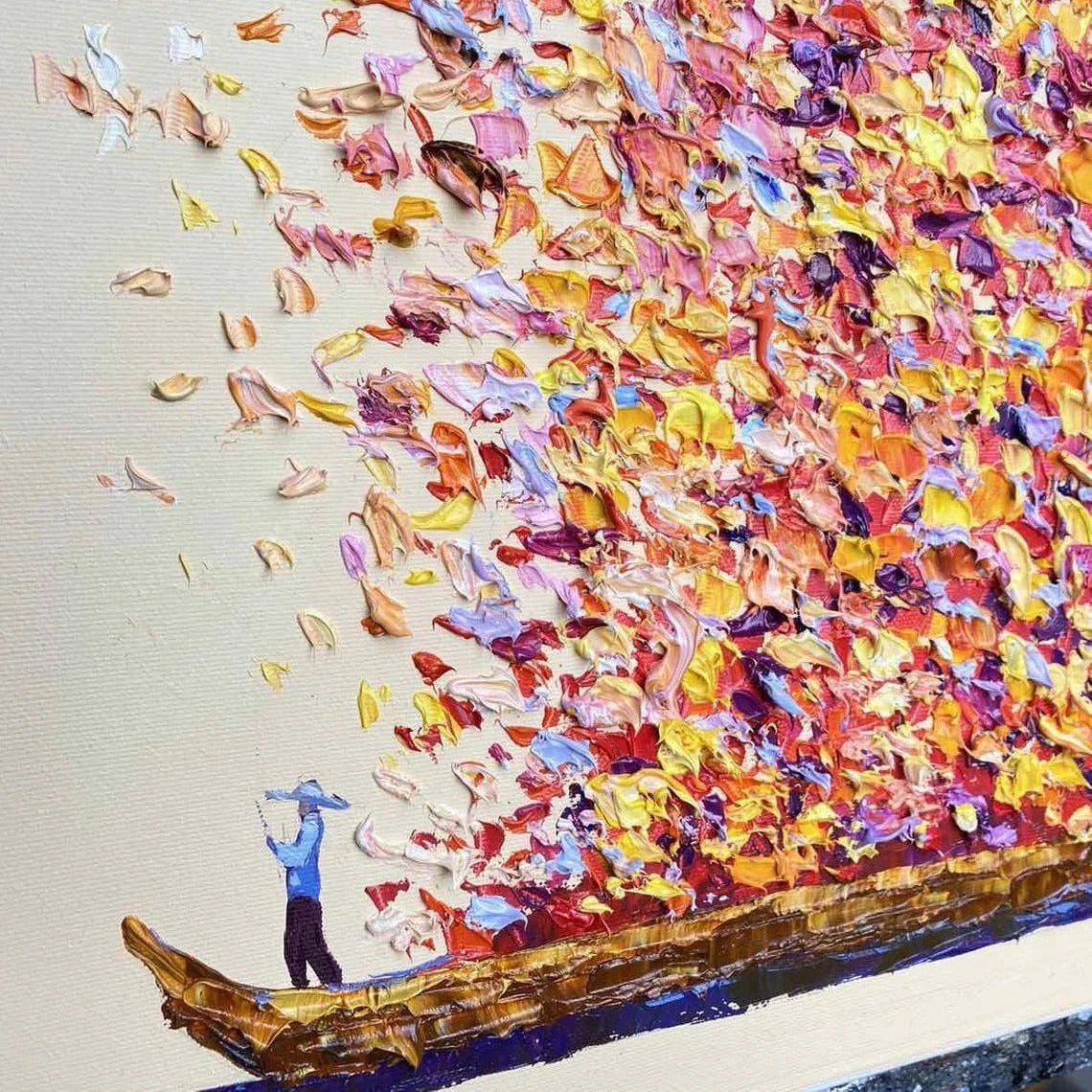 The image is a vibrant painting depicting a person standing on a boat surrounded by a multitude of colorful leaves.
