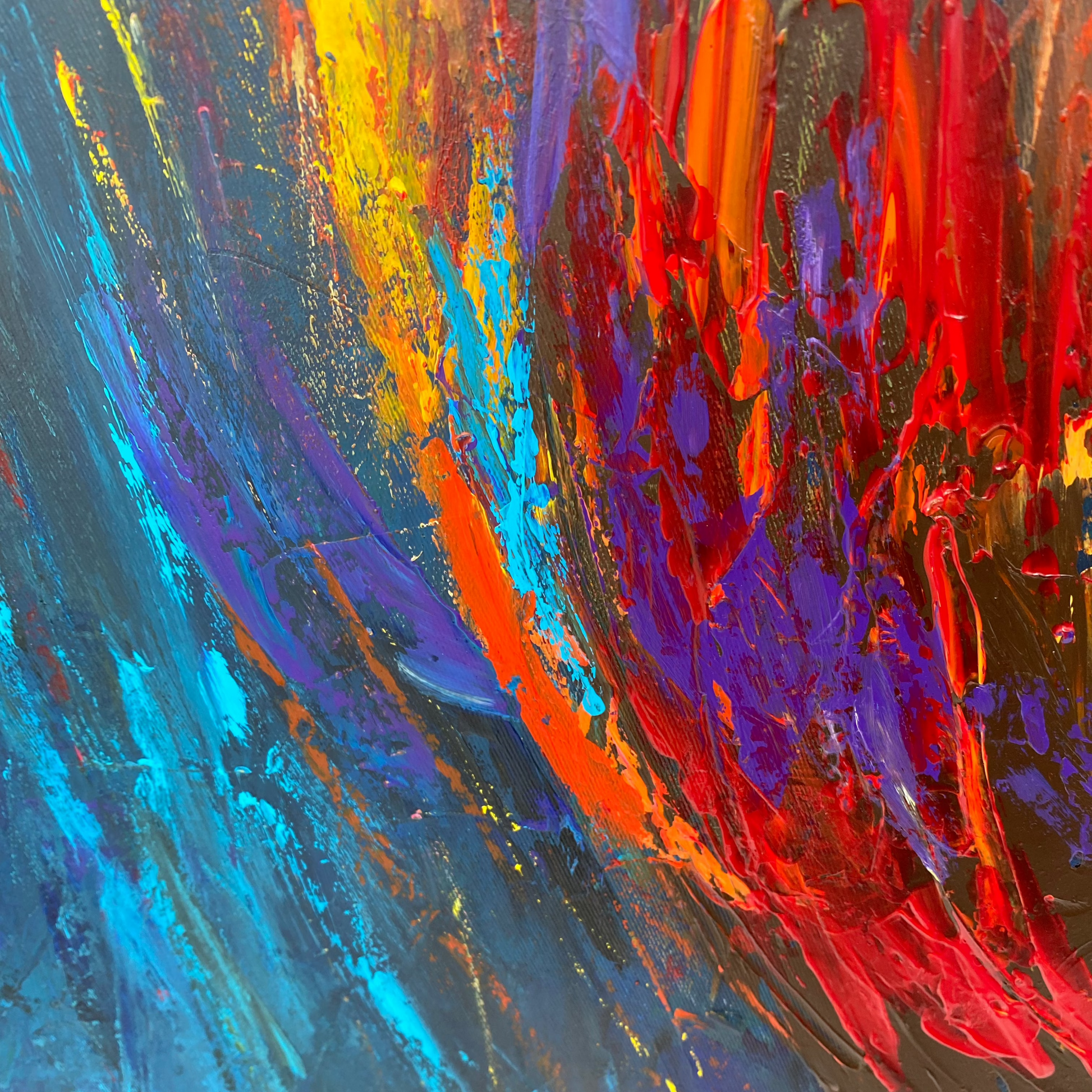 The image is a vibrant abstract painting with bold strokes of red, blue, and yellow. The painting features a dynamic and energetic composition, with the colors and brushstrokes creating a sense of movement and emotion.