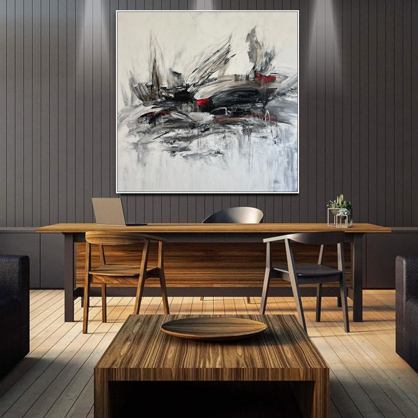 a painting hanging on a wall above a wooden table