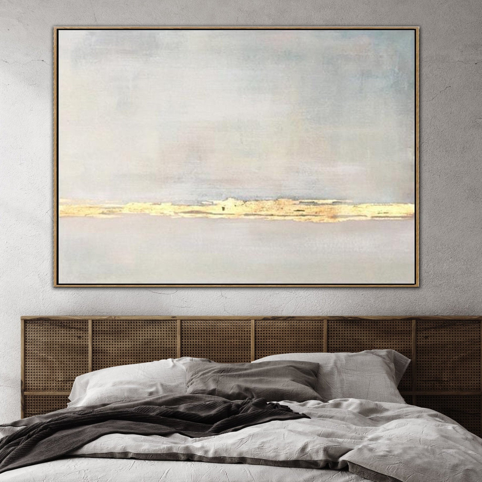 a large, abstract painting hanging on a wall above a bed with a wooden headboard.