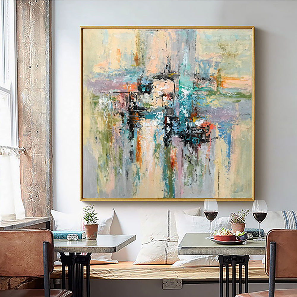 a painting hanging on a wall above a dining room table