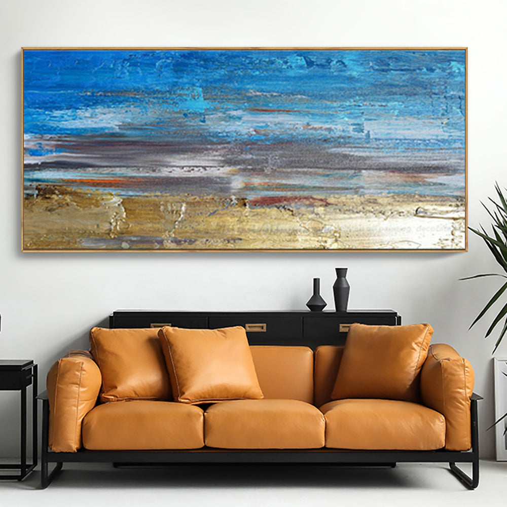 a living room with a couch and a painting on the wall