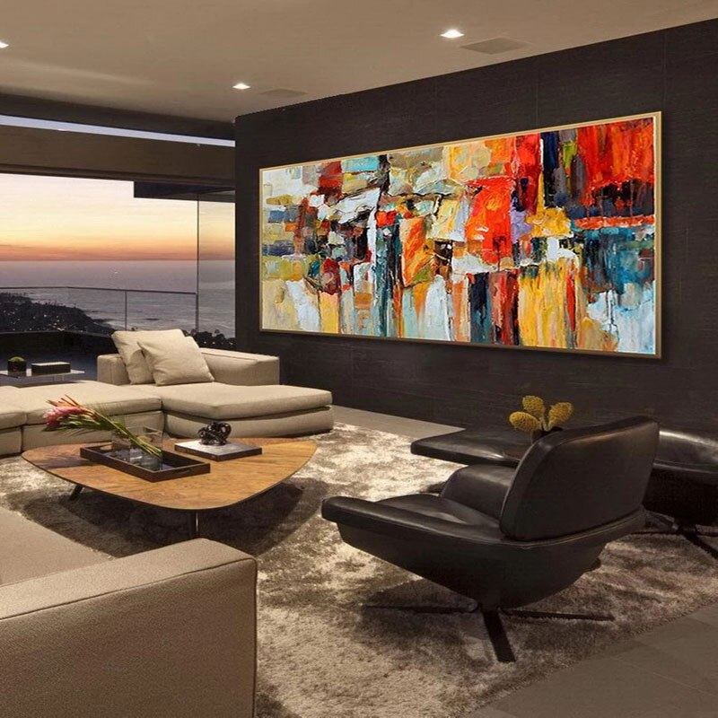 a living room filled with furniture and a painting on the wall