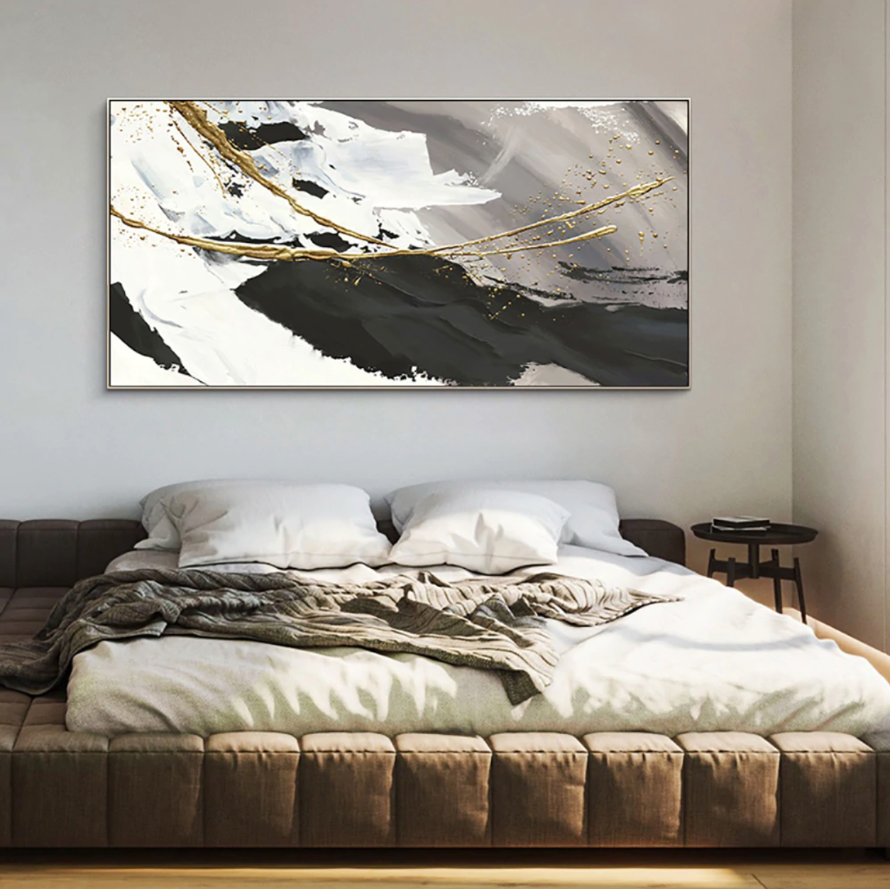 a bedroom with a bed and a painting on the wall