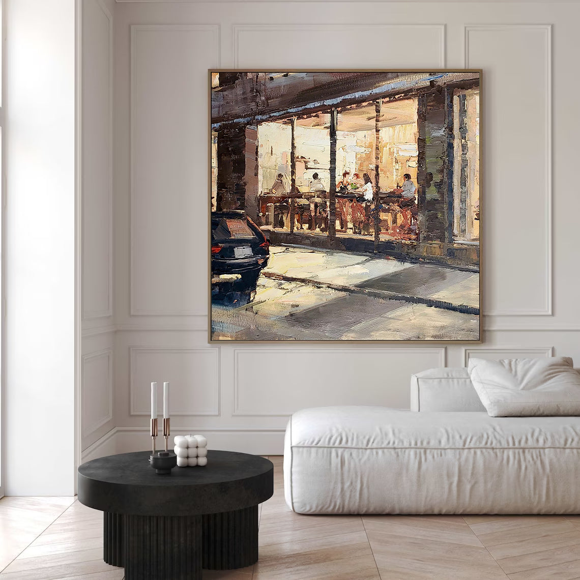 a living room with a couch and a painting on the wall