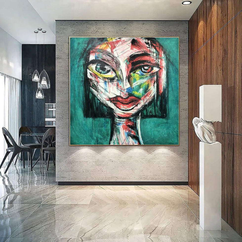 a large, colorful abstract painting of a face on a wall, with a modern and minimalist interior design in the background.