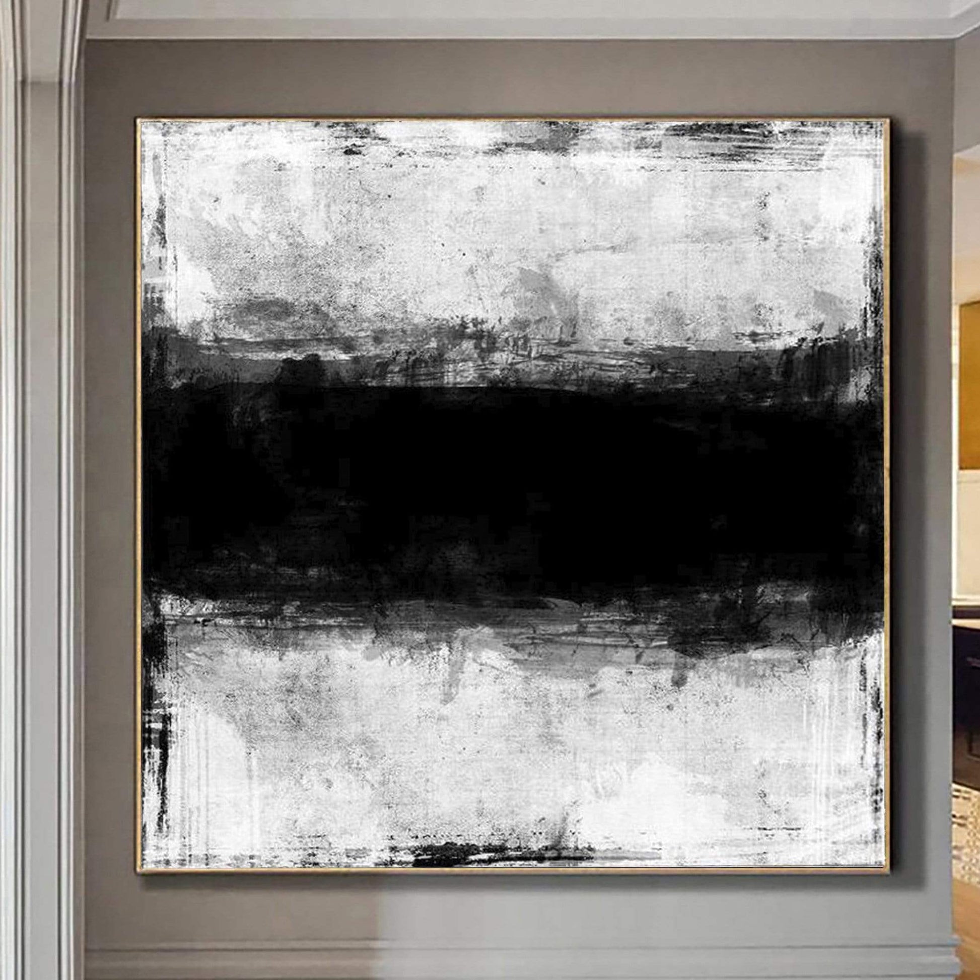 a large black and white painting hanging on a wall