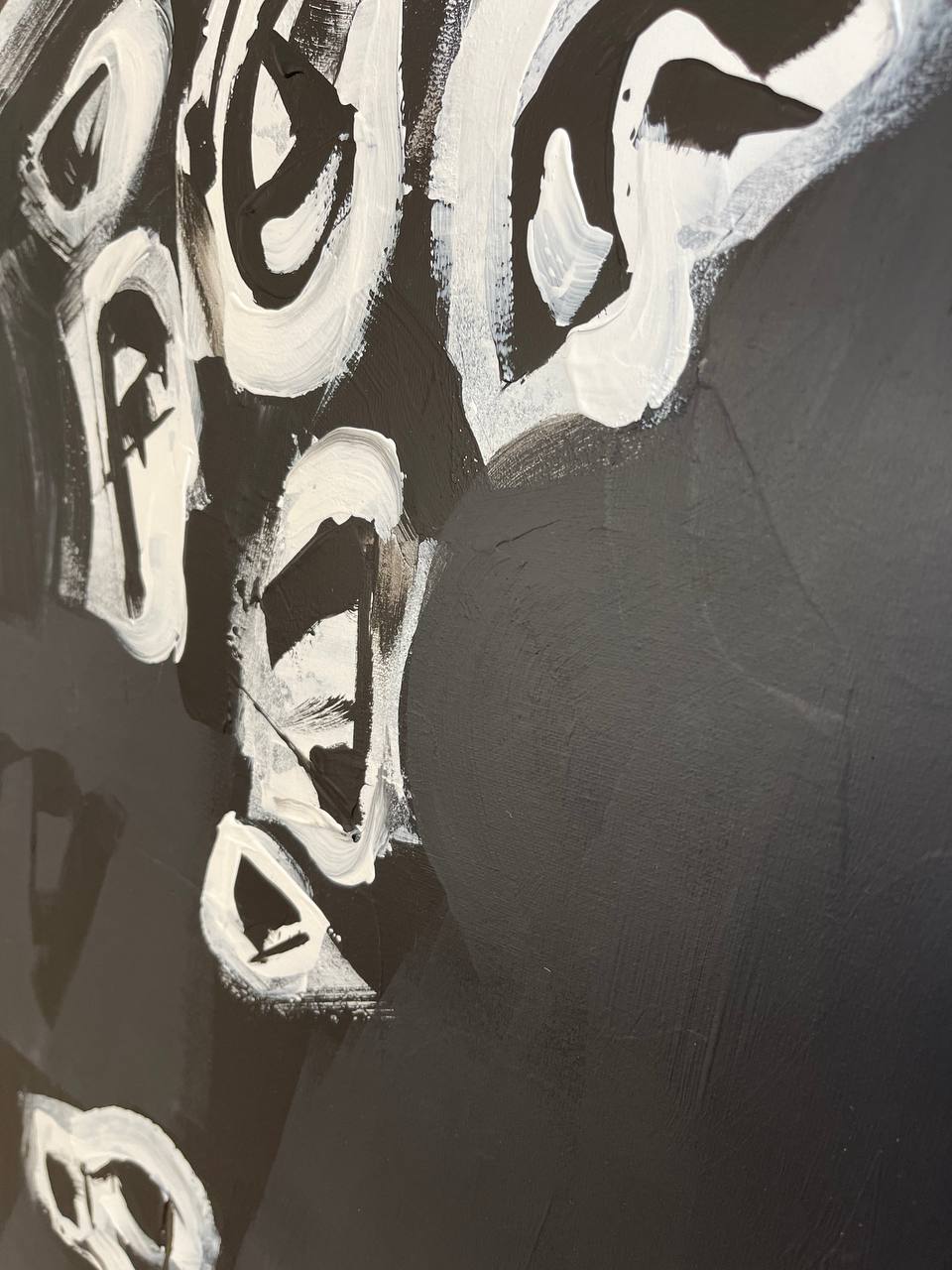 a close up of a black and white painting