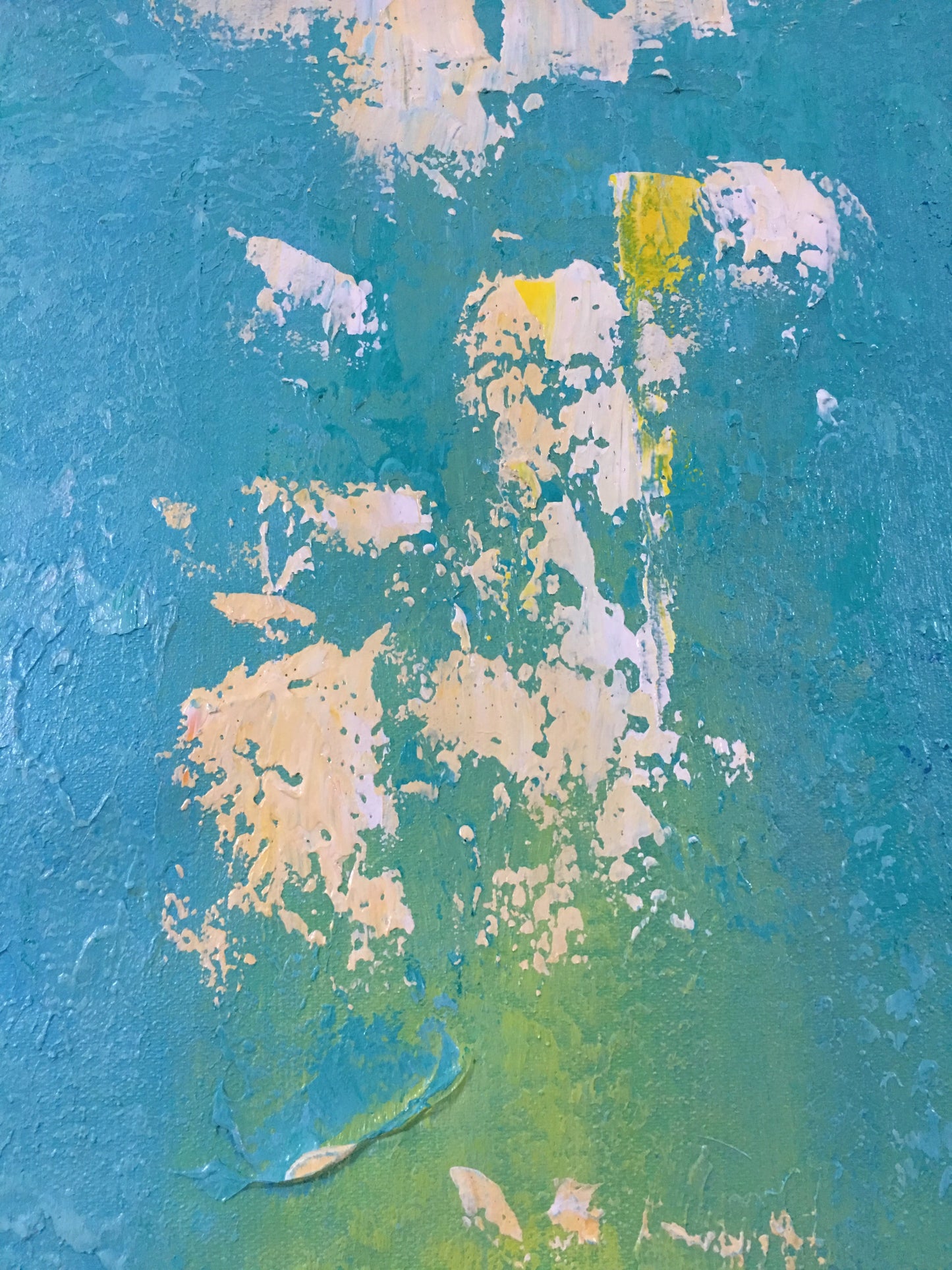 a close up of a blue and yellow wall with peeling paint