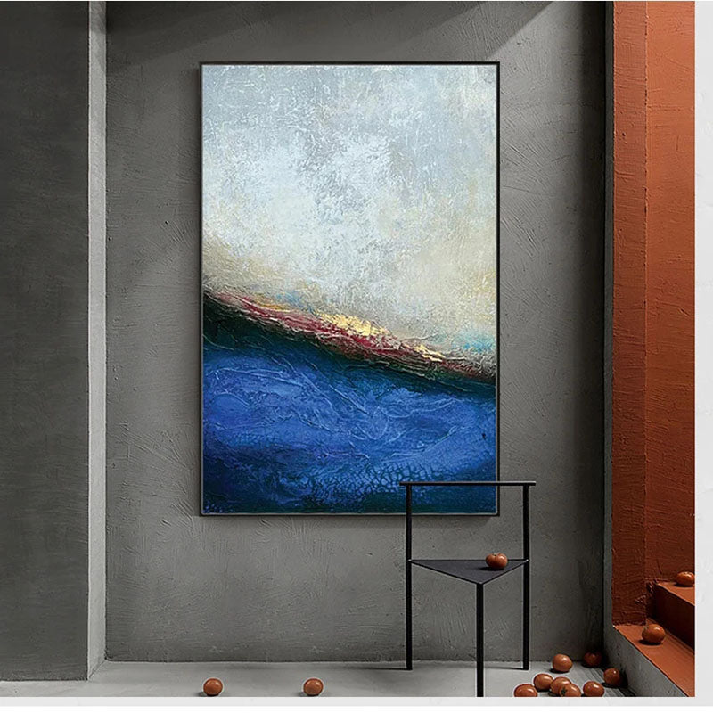 a painting hanging on a wall next to a chair