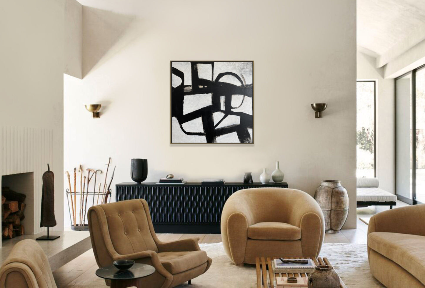 a living room filled with furniture and a painting on the wall