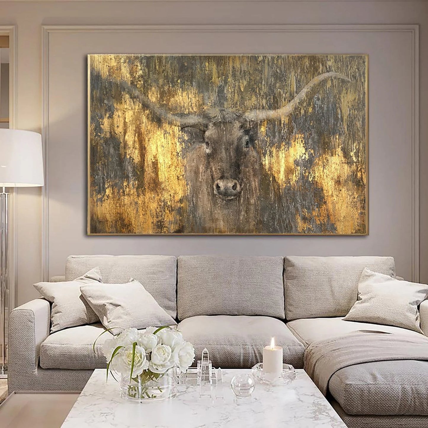 a large, framed painting of a bull's head on the wall of a living room.