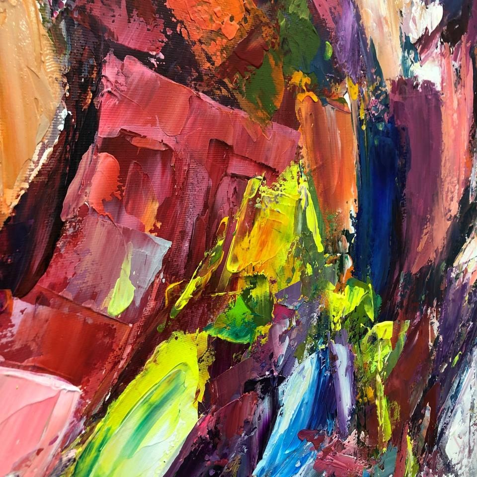 The image is a vibrant, abstract painting with bold, expressive brushstrokes in a variety of colors including red, orange, yellow, green, blue, and purple. The painting appears to be a dynamic, energetic composition with a sense of movement and energy.