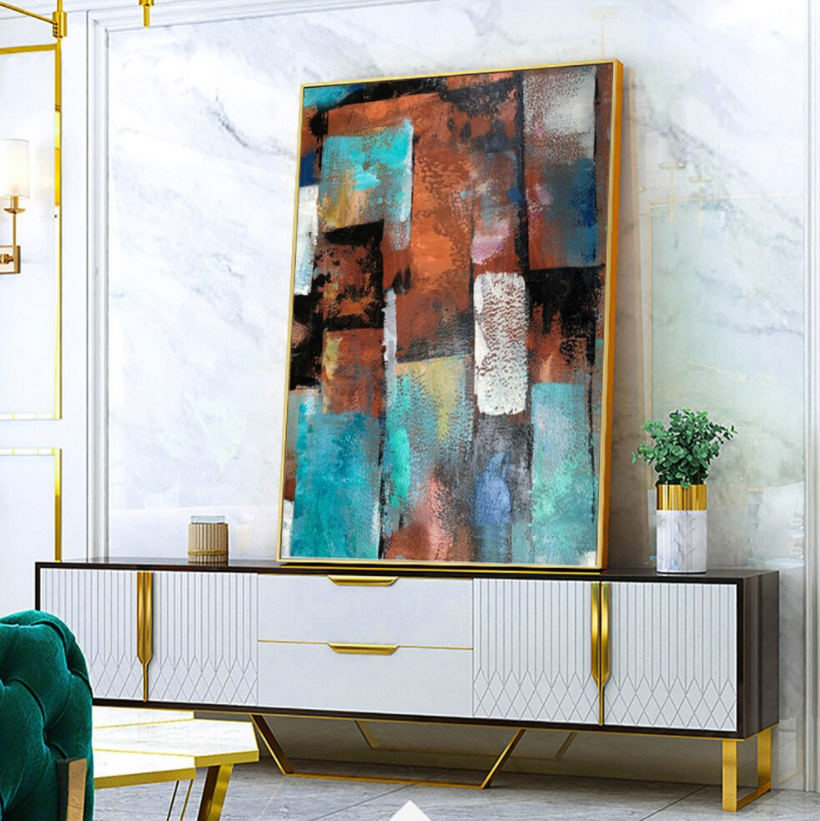 a living room with a painting on the wall