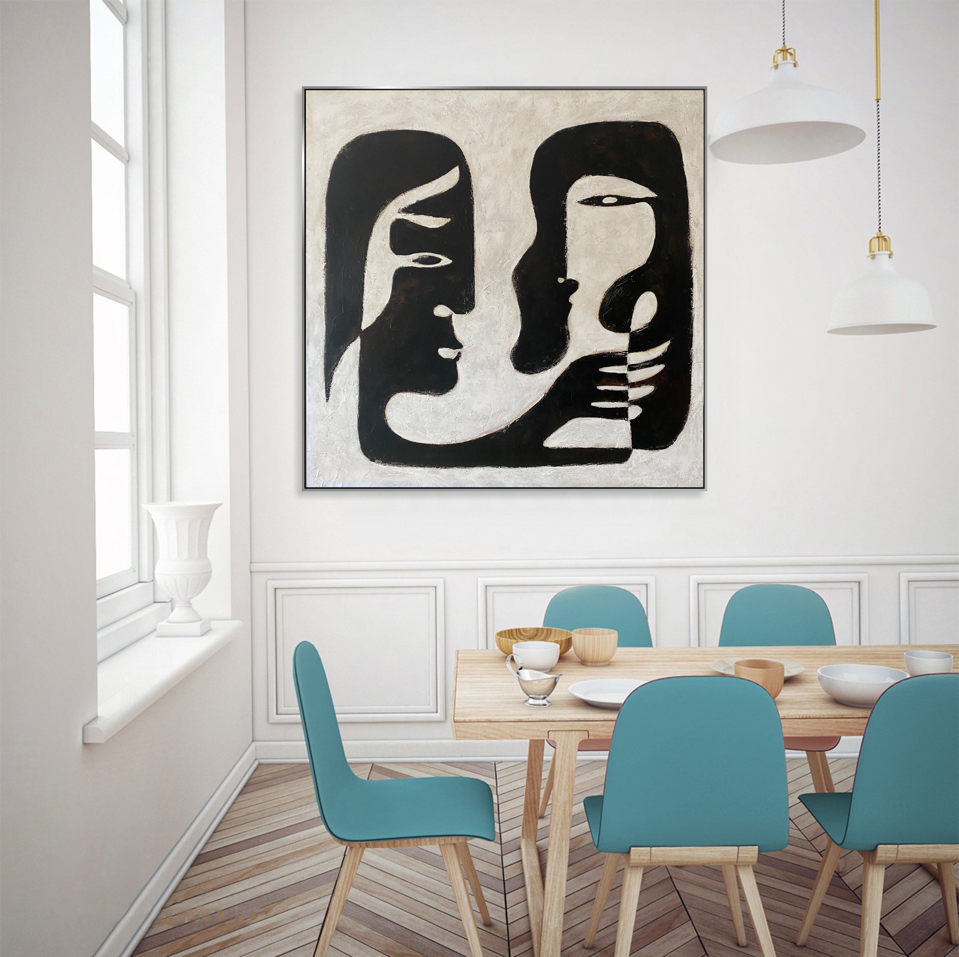 a dining room with a painting on the wall