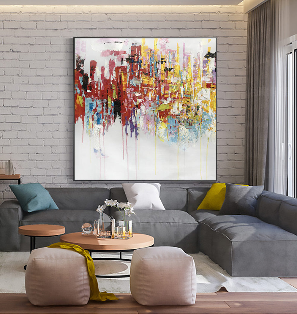 a living room filled with furniture and a painting on the wall