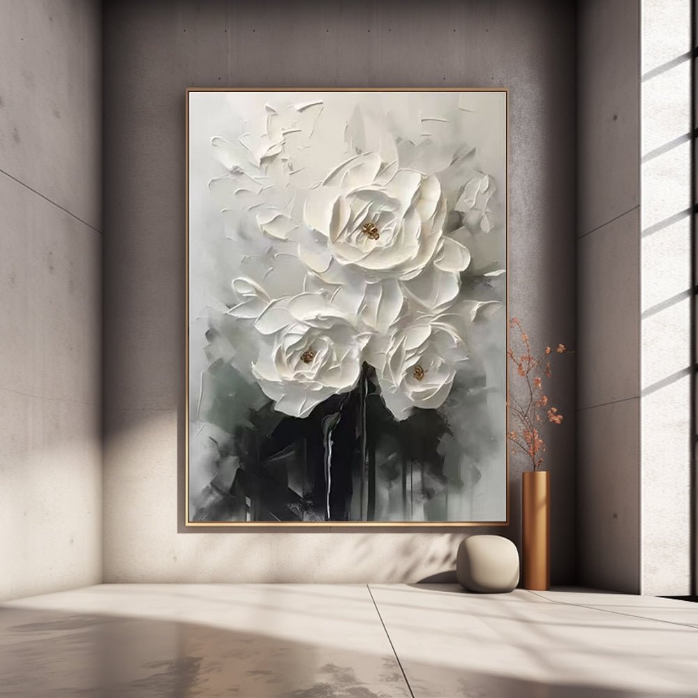 a large, framed painting of white flowers hanging on a wall in a minimalist setting.