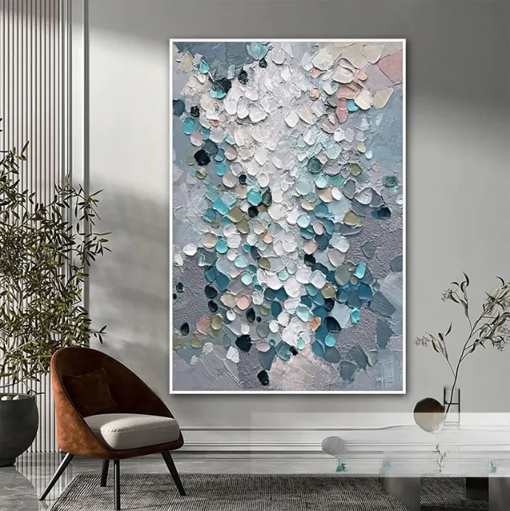a large abstract painting hanging on a wall, with a brown chair and a glass table in the foreground.
