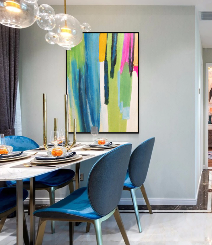 a dining room table with blue chairs and a painting on the wall