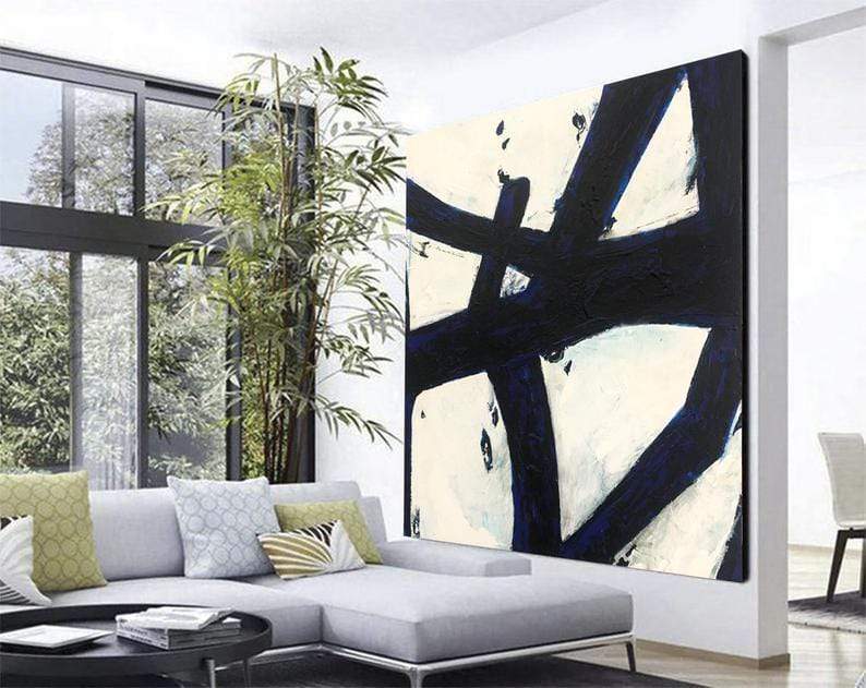 a living room with a large painting on the wall