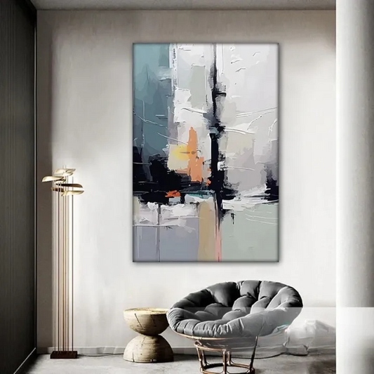 a modern living room with a large abstract painting hanging on the wall, a gray armchair, and a wooden side table.