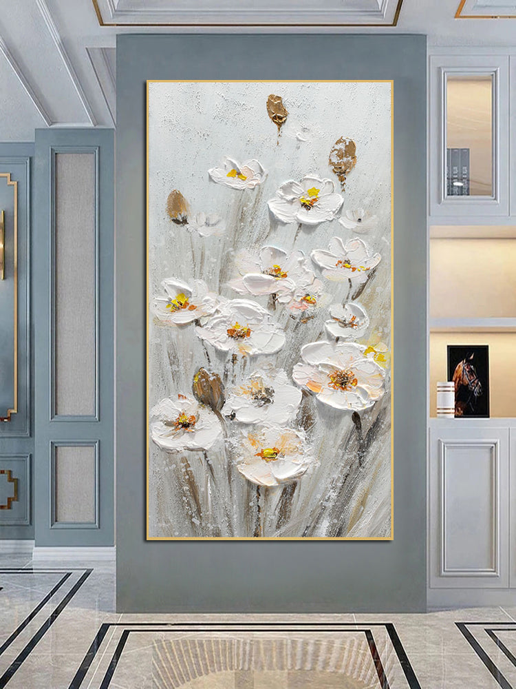 a painting of white flowers on a gray wall