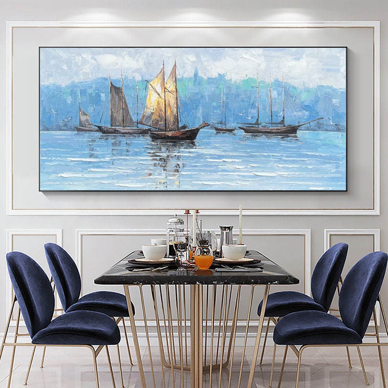 a painting of sailboats on the water in a dining room