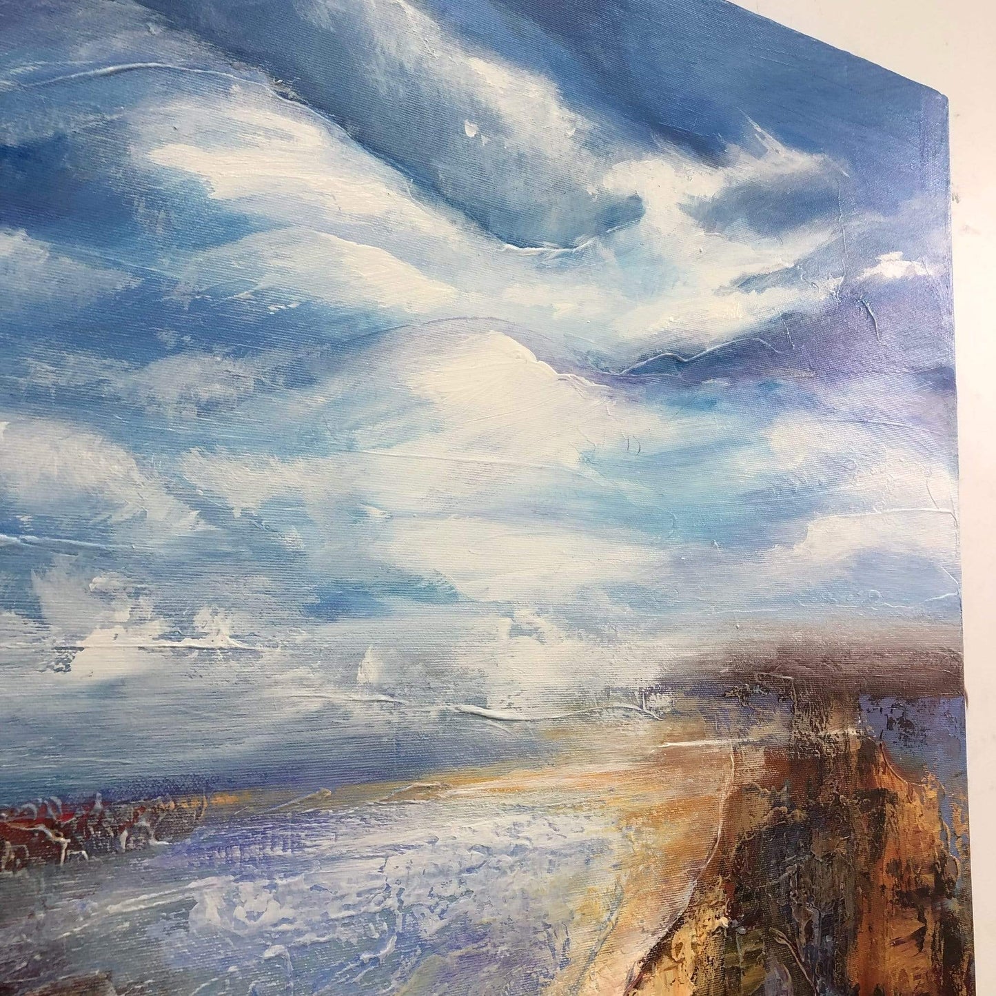 a painting of a beach with a cloudy sky