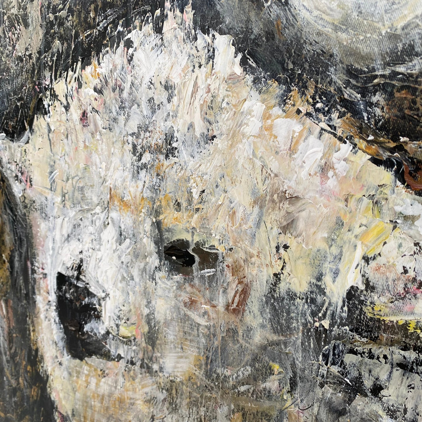 The image is an abstract painting with a mix of black, white, and yellow colors. The painting has a textured and expressive appearance, with visible brushstrokes and layers of paint creating a dynamic visual effect.