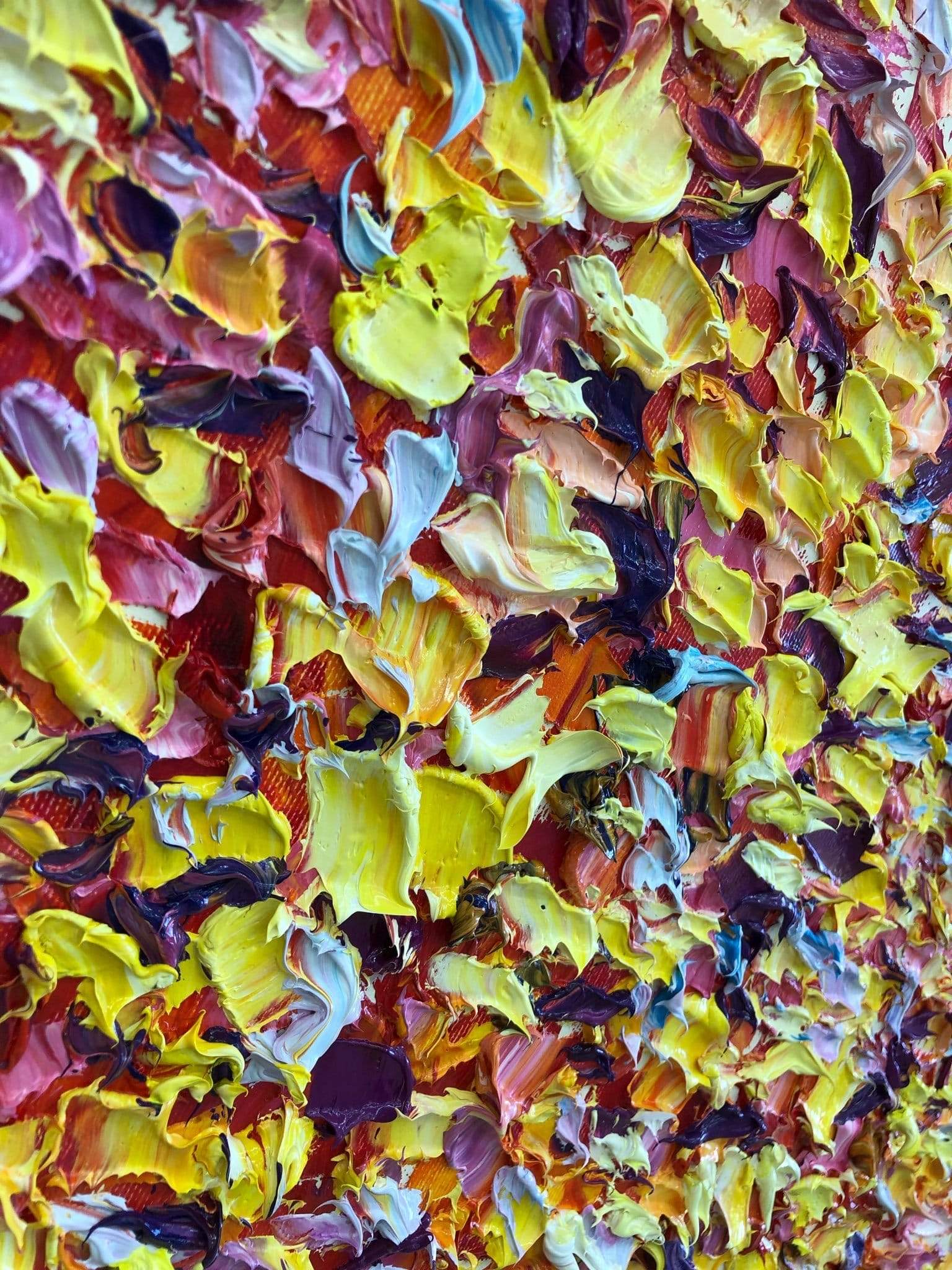 a wall covered in lots of different colored flowers