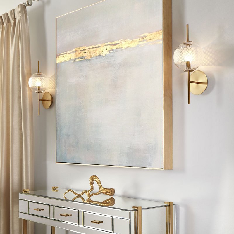 a large painting hanging on a wall above a console table