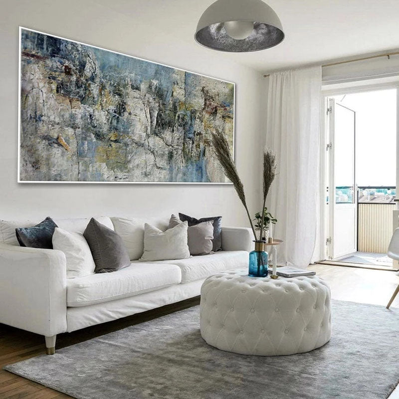 a living room with a large painting on the wall